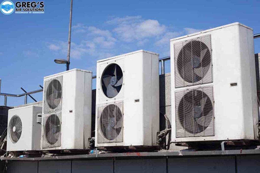 Commercial rooftop with multiple air conditioning units, including **AC fan motors**, arranged for optimal cooling performance.
