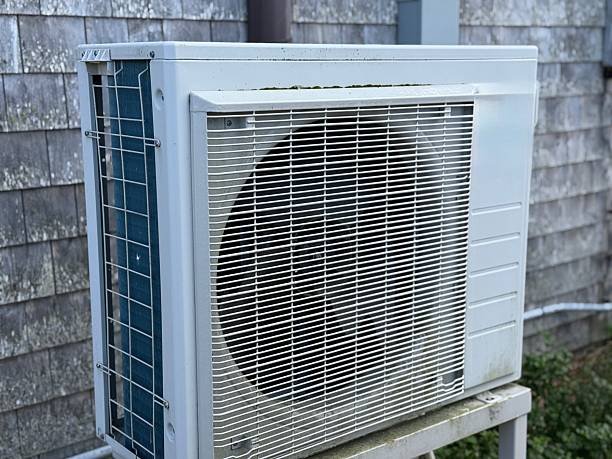 A white air conditioner on a sturdy metal stand, showcasing its HVAC functionality.