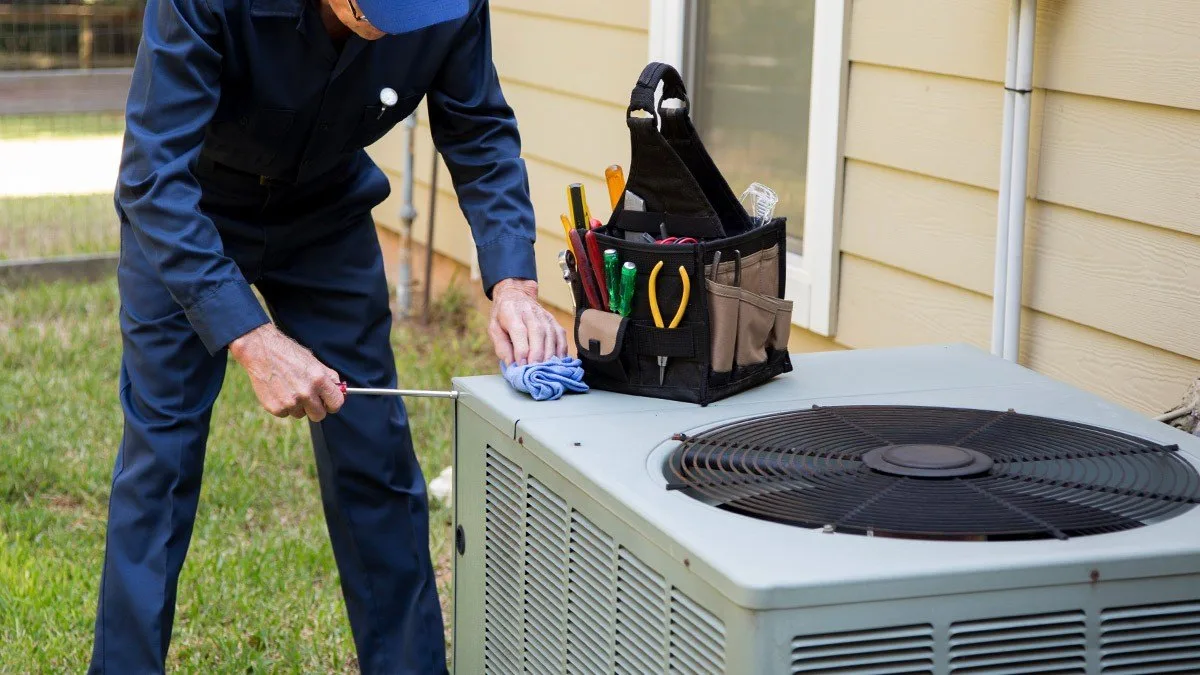 HVAC unit service being performed on commercial rooftop system in Florida heat