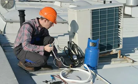 Qualified installer performing an HVAC installation on an outdoor split system unit